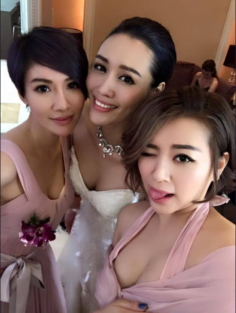 This bridesmaid wears a low-cut dress with a beautiful, fresh look, but what really grabs attention is her bust.