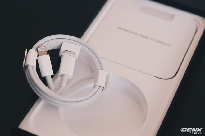 The iPhone 12 box includes only a USB-C to Lightning cable, no charger or earphones