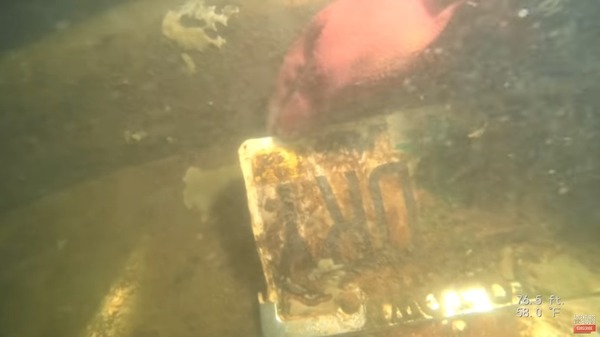 The team accidentally found a mysterious car submerged in trash during their cleanup