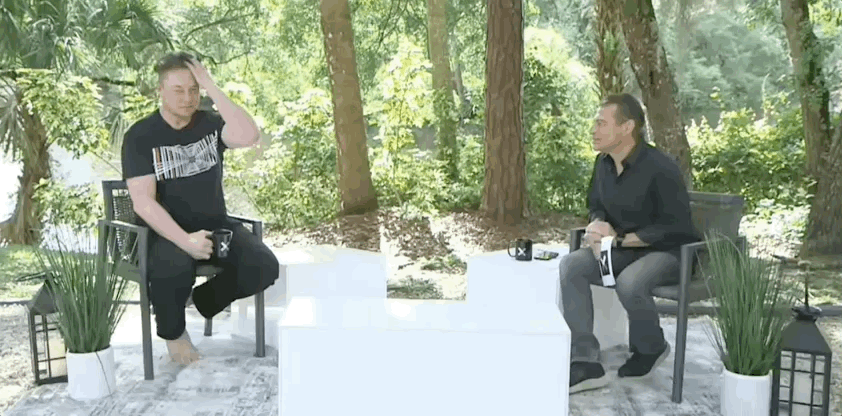 Elon Musk barefoot while discussing moon plans with Peter Diamandis.