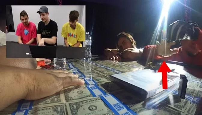 Excitement fades as the first player gives up and removes their hand from the cash pile