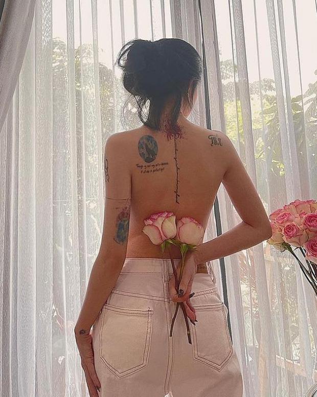 Linh Ngọc Đàm tattoo on back with meaningful numbers