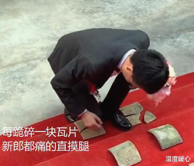 Groom kneeling on tiles during wedding challenge