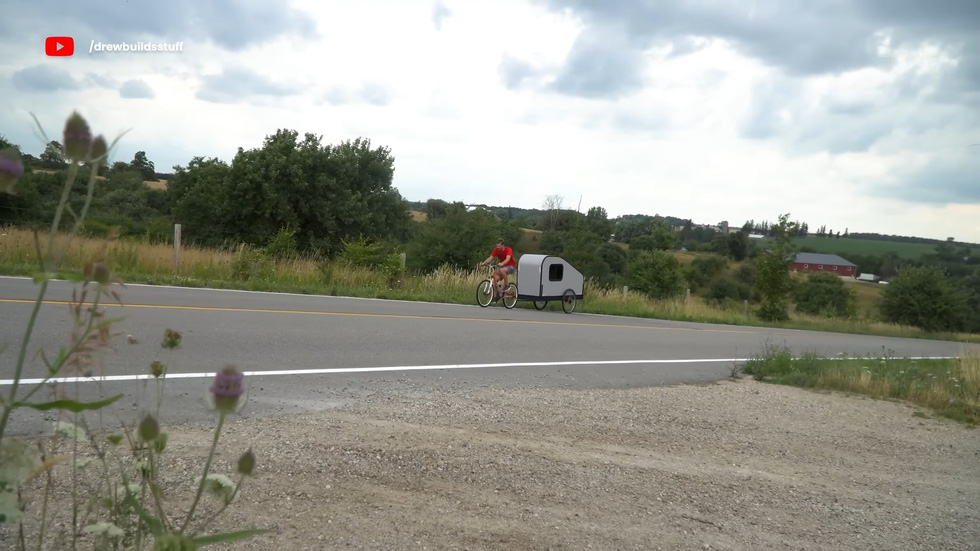 Cycling uphill while towing a 'house' behind is no easy feat - Photo: Drew Builds Stuff/YouTube