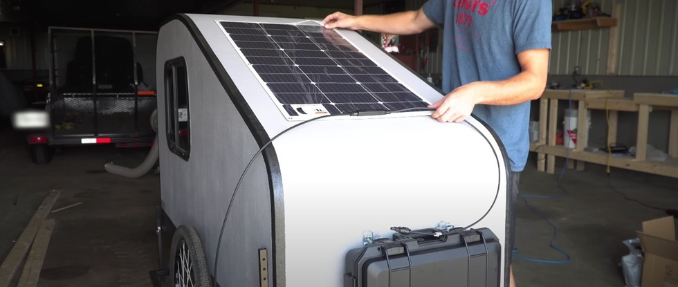 He mounted a 100W solar panel on the roof, wiring it to a backup charger inside the mobile home - Photo: Drew Builds Stuff/YouTube