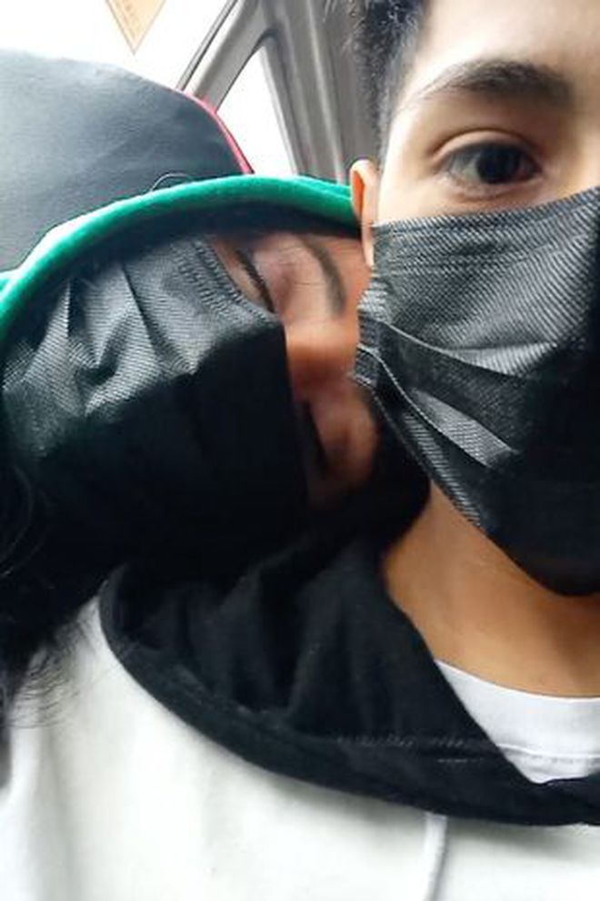 The girl casually resting her head on the guy's shoulder on the bus