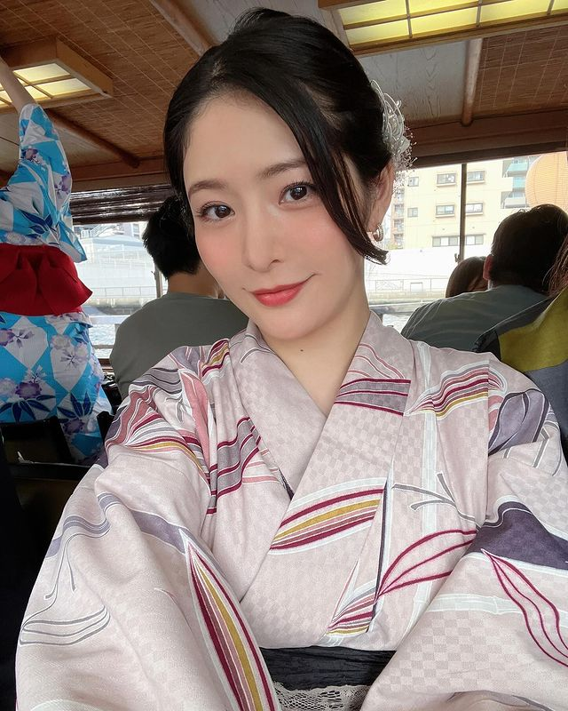 Megumi smiling in a casual outfit