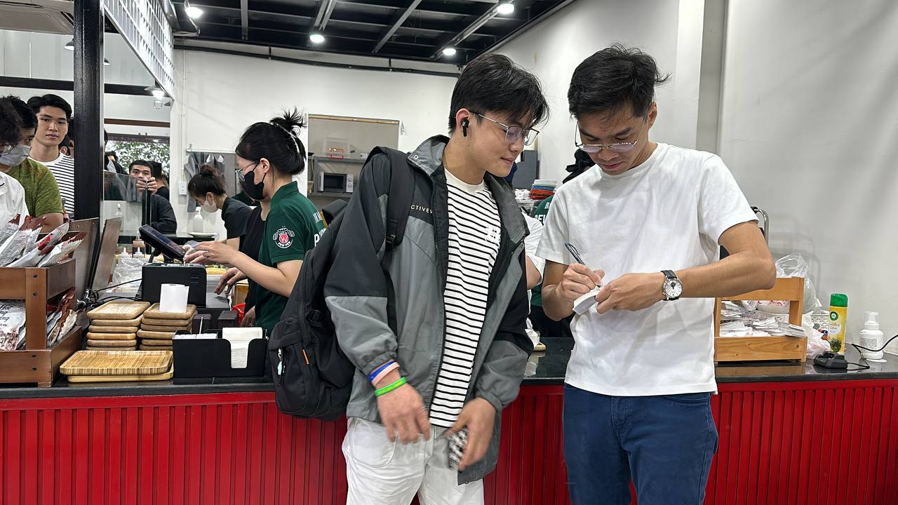 PewPew chatting and signing autographs for some customers.