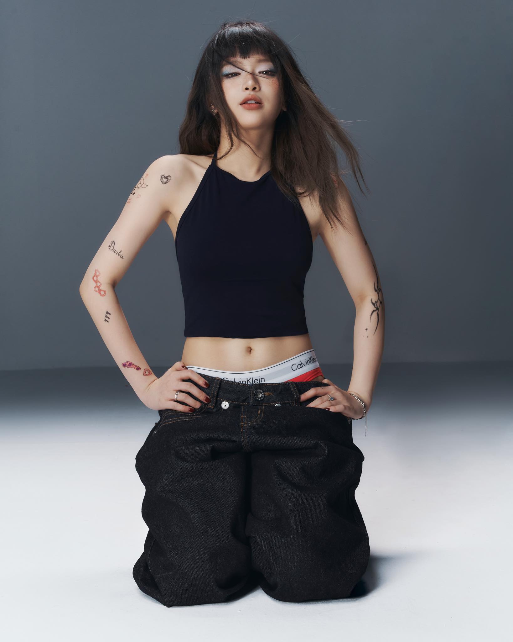 Linh Ka posing confidently in stylish outfit