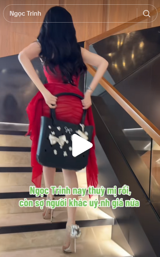 Ngọc Trinh adjusting her dress