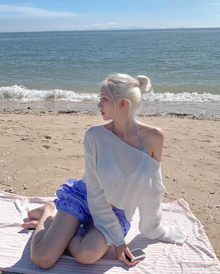 Eungee in a white ruffled dress