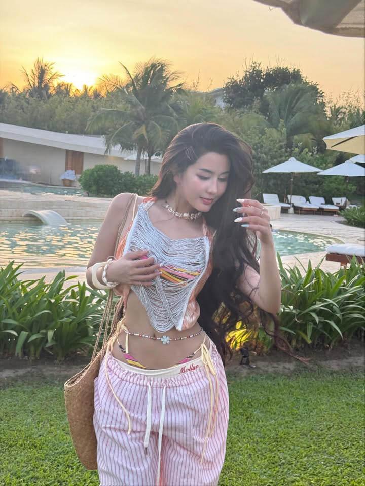 Ngoc Tran Stuns Fans with Summer Bikini Photos 9 Ngoc Tran in bright striped bikini with belly chain