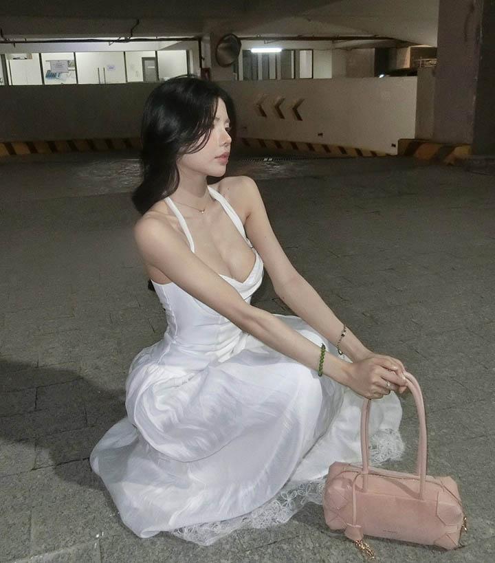 Mai Dora Shares Stunning Photos with a Fan-Favorite Name 2 Mai Dora in a mystical white dress at a dimly lit parking lot
