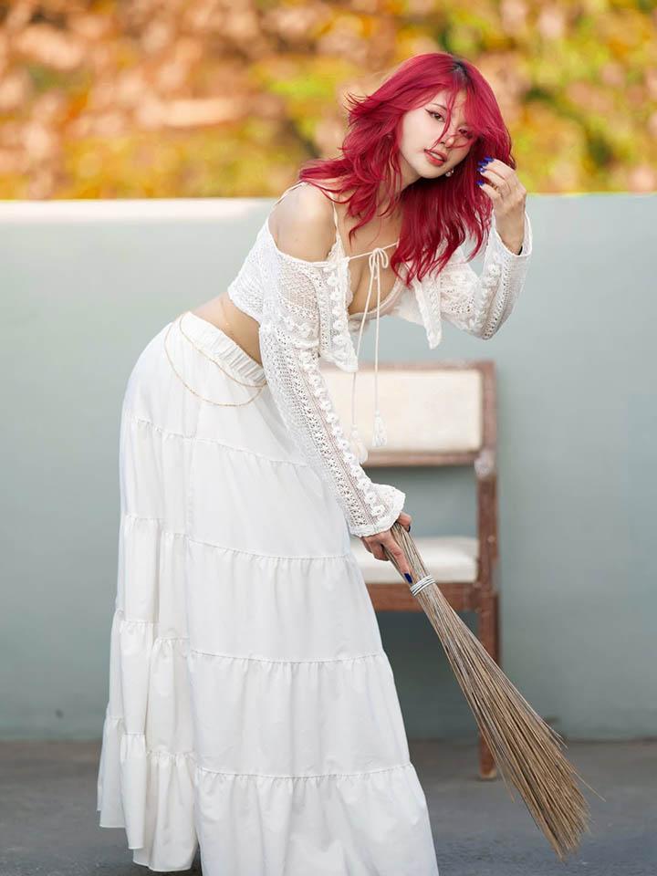 Charess with vibrant red hair and flawless skin