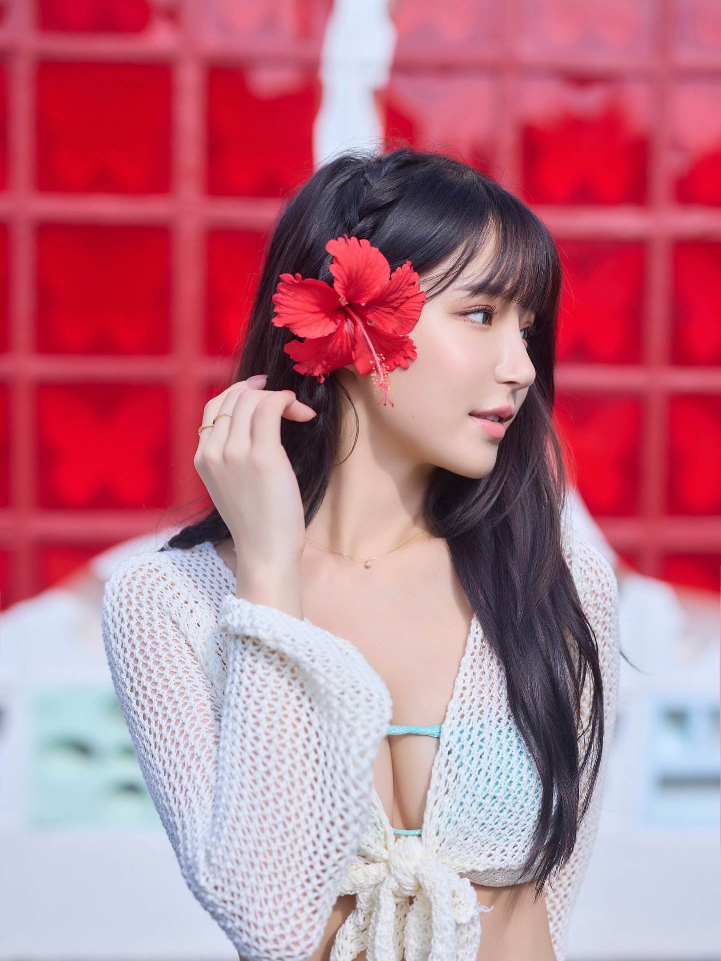 Close-up of Yuan Yuan with a red flower in her hair