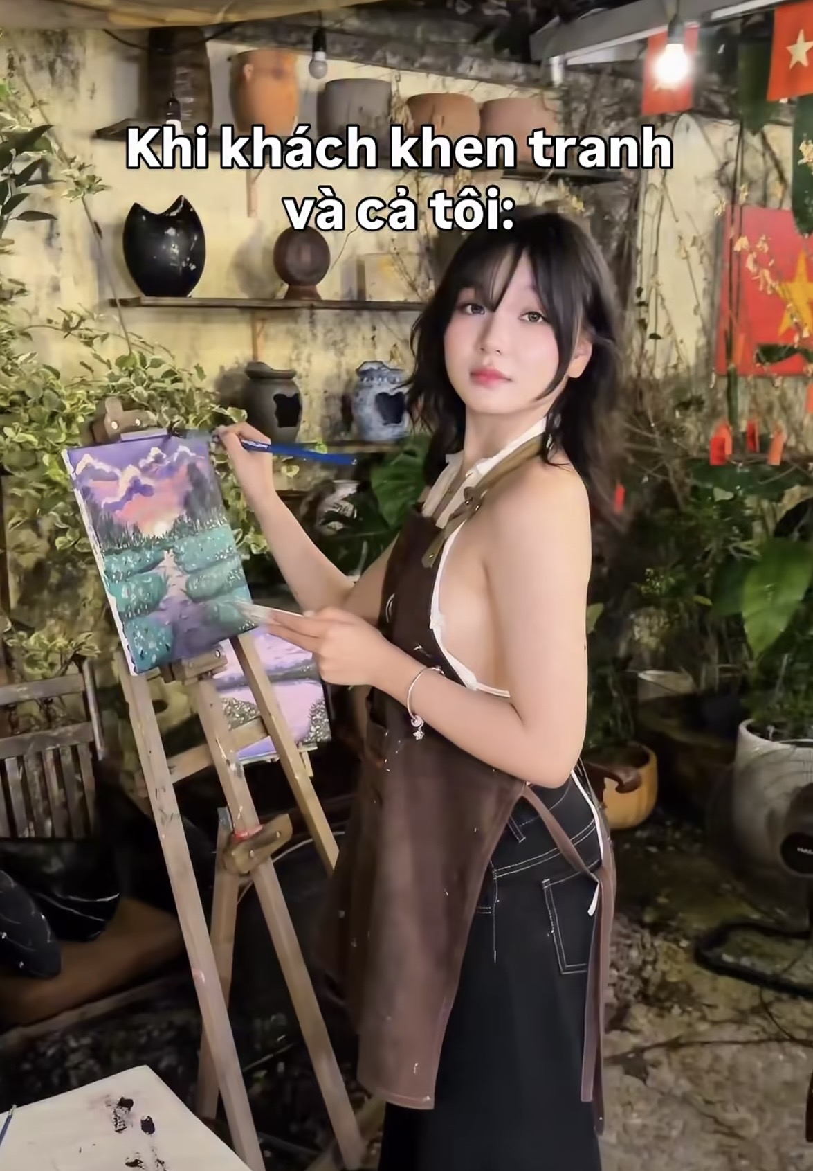 Young woman painting with a bright smile