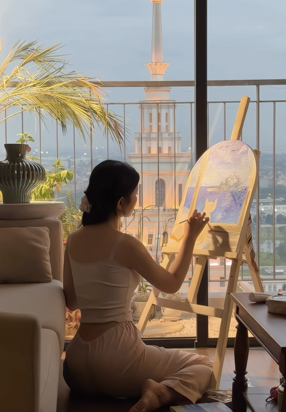 Le Bong smiling with her finished painting