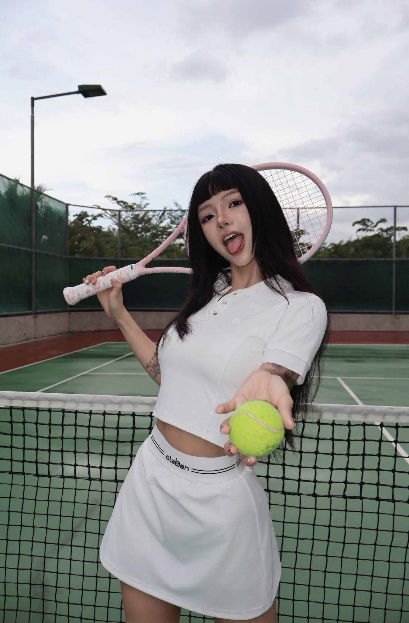 TikTok Star Ciin Stuns in Sleek Tennis Outfit 6 Ciin posing with tennis racket