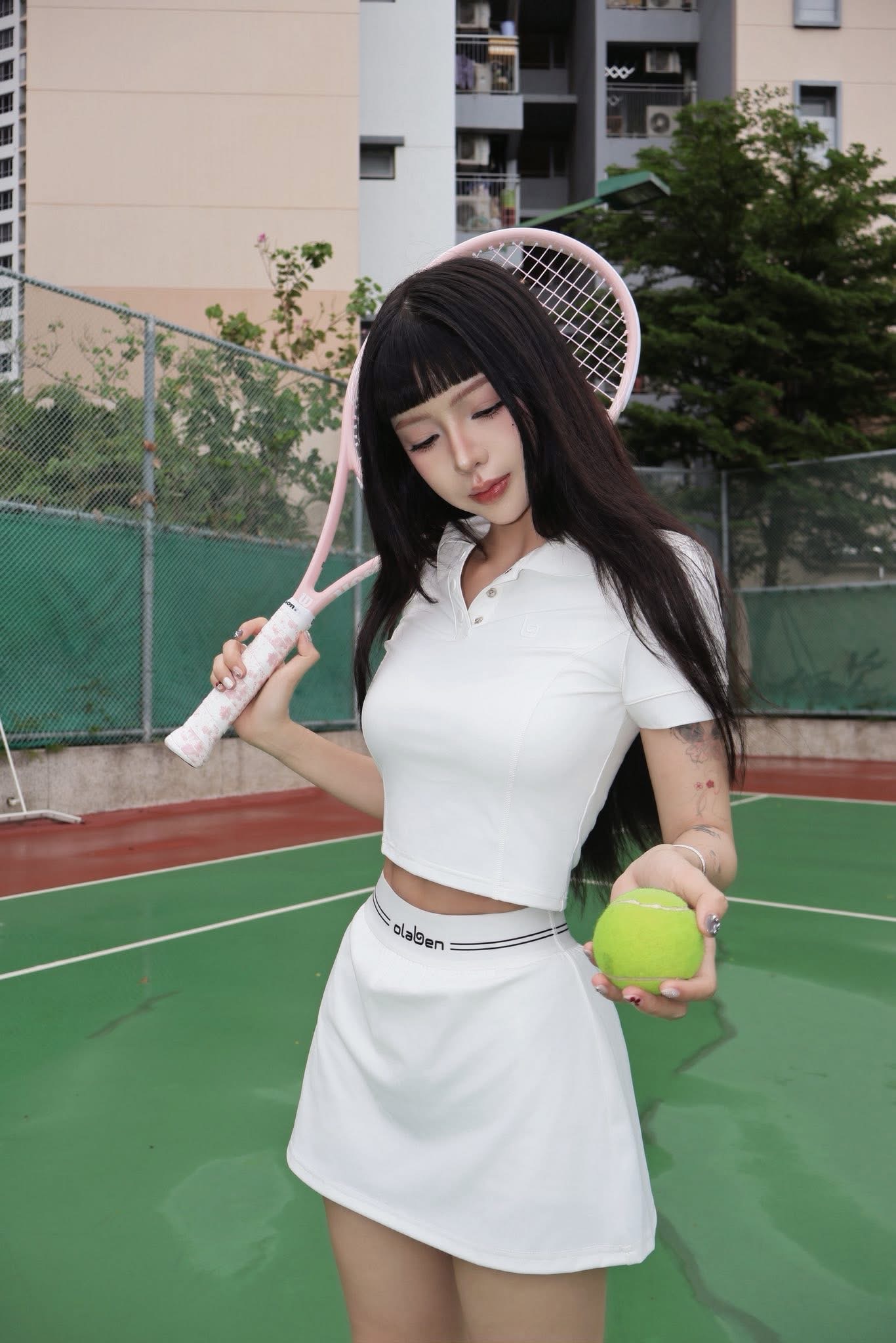 TikTok Star Ciin Stuns in Sleek Tennis Outfit 1 Ciin posing on tennis court in sporty outfit