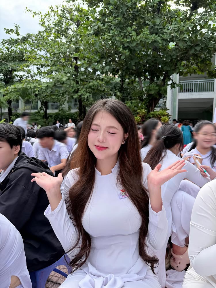 Girl posing confidently in white ao dai