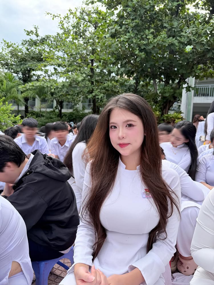High school girl in white ao dai with soft curls
