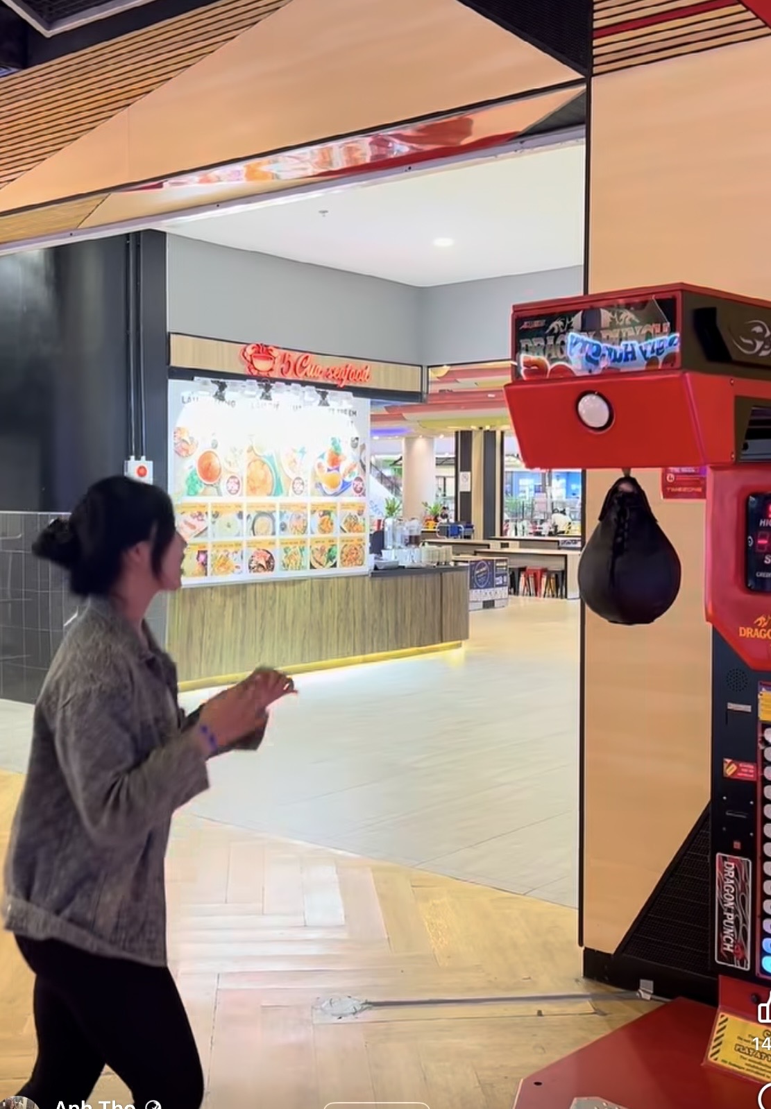 Anh Tho preparing to punch the game machine