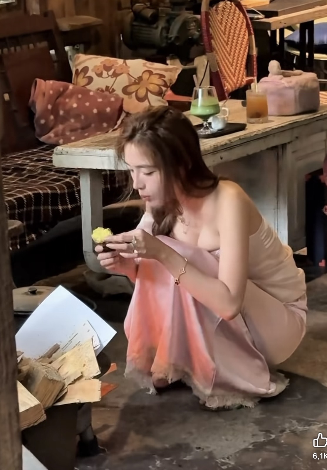 Hot girl eating sweet potato by the fire