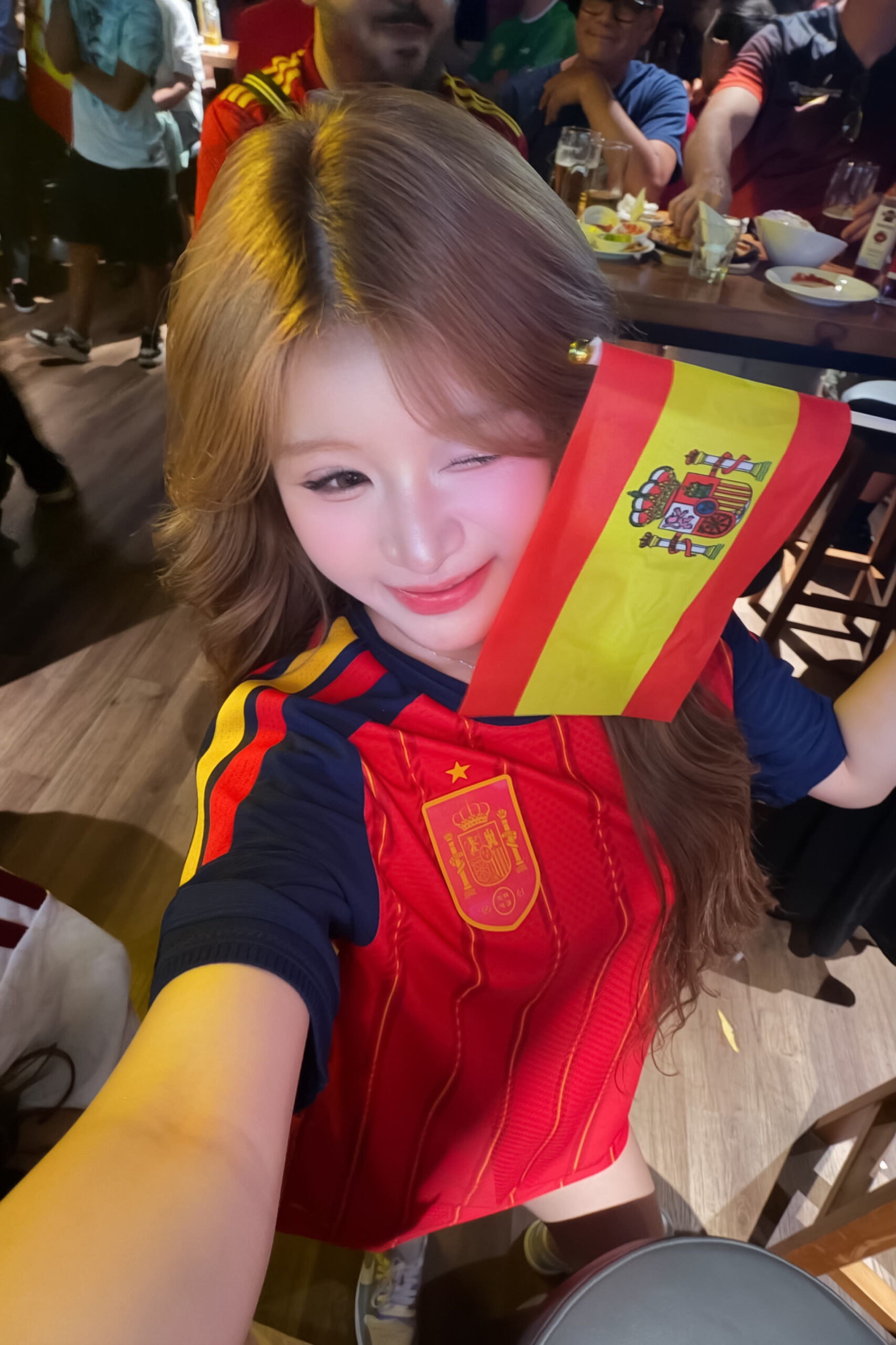 Spanish Football Fan Steals the Spotlight with Sweet Look 3 Spanish fan with curled light hair and flag