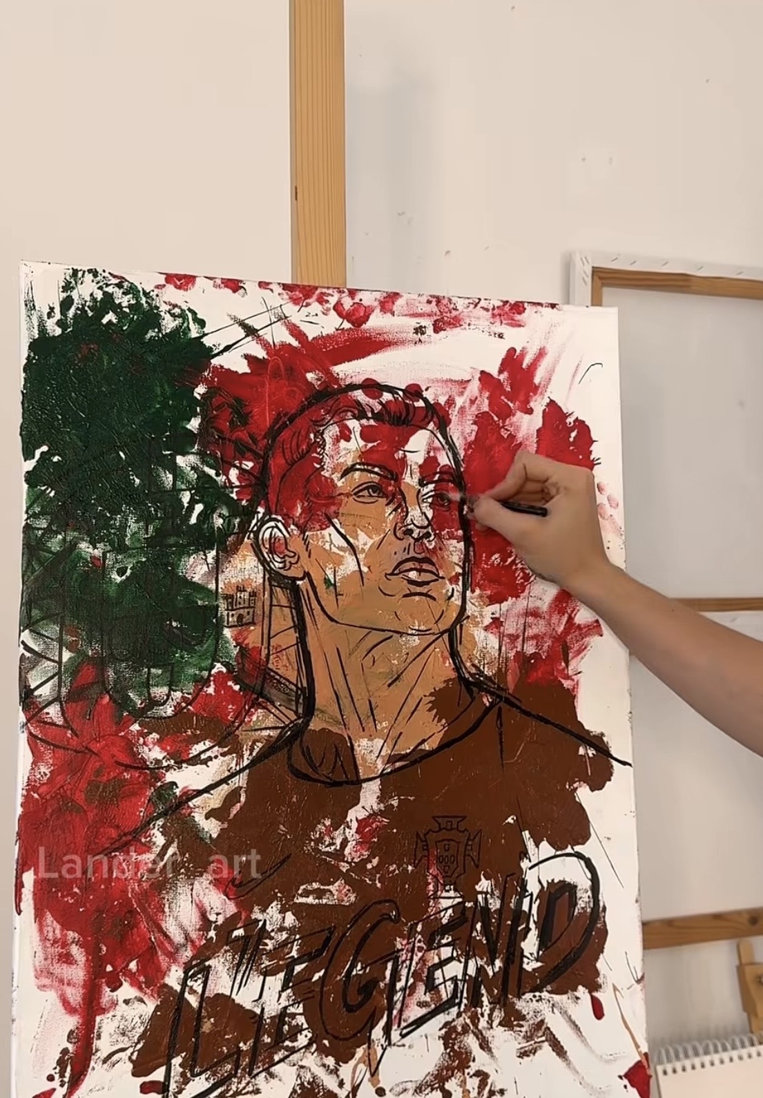 Artist Lander_art Paints Ronaldo Portrait Using a Soccer Ball 4 Canvas with paint splashes from soccer ball