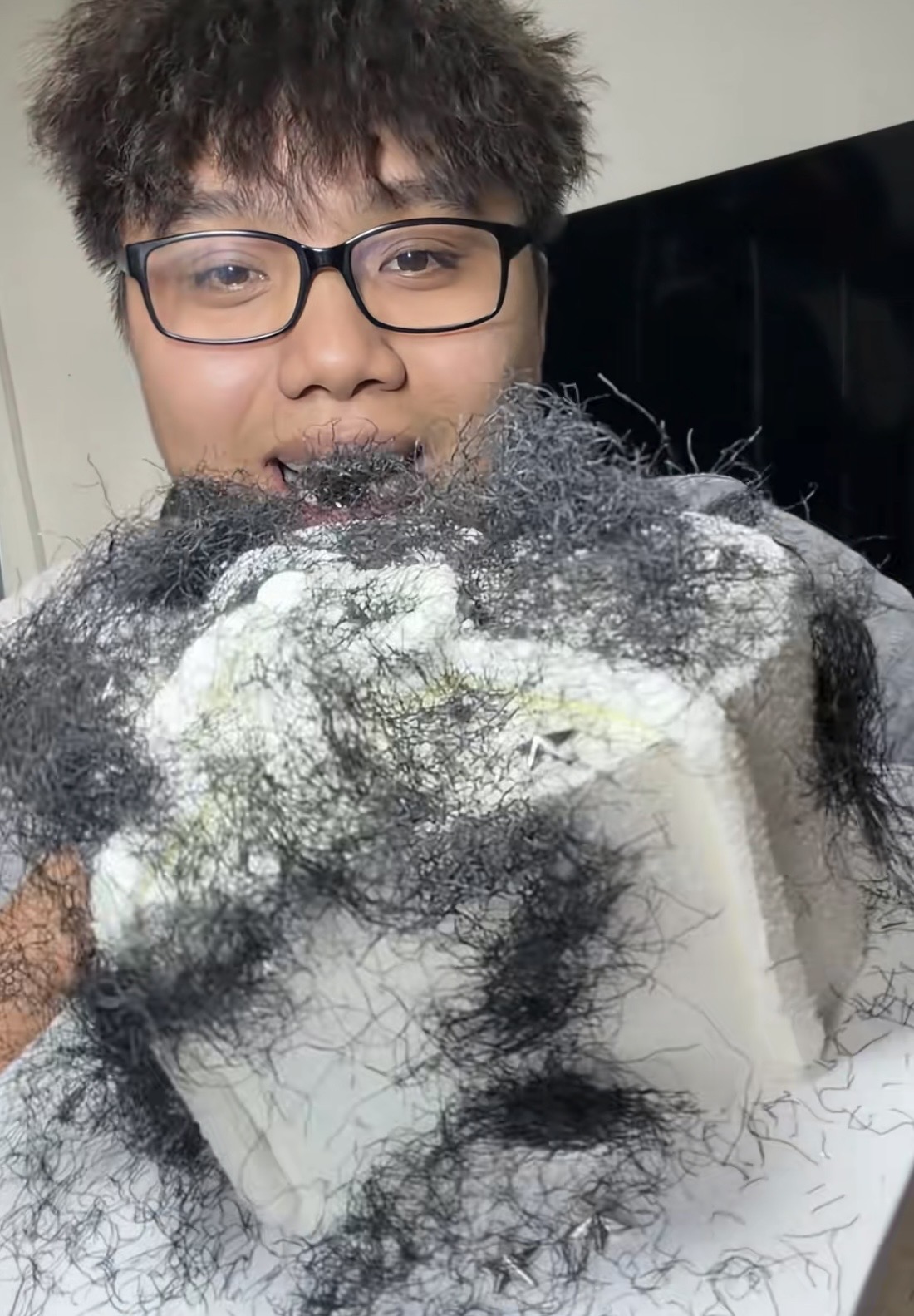 The Creepiest Cake Trend Taking Over TikTok 1 Fairy hair cake with black curly strands on white frosting