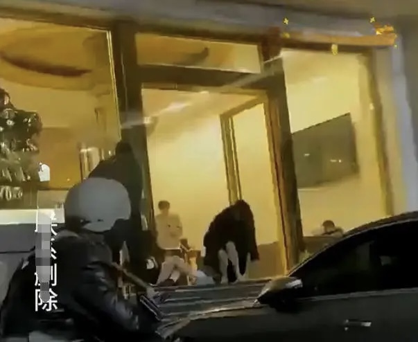 Three drunk people outside karaoke bar