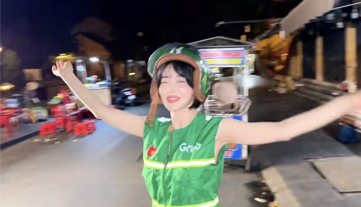 DJ Soda Rocks Hoi An in Grab Driver Outfit 3 DJ Soda smiling in Grab outfit
